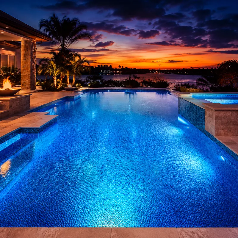 Freshly remodeled pool with new pebble finish at dusk